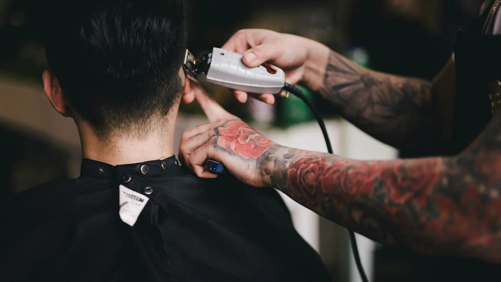 Barber working clippers on a fade